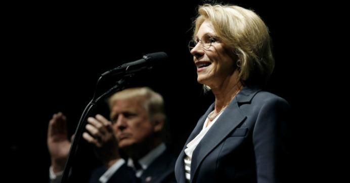 Donald Trump applauds as Betsy DeVos speaks at Trump's "Thank You USA" rally in Grand Rapids, December 9, 2016. (Photo: Reuters/Mike Segar)