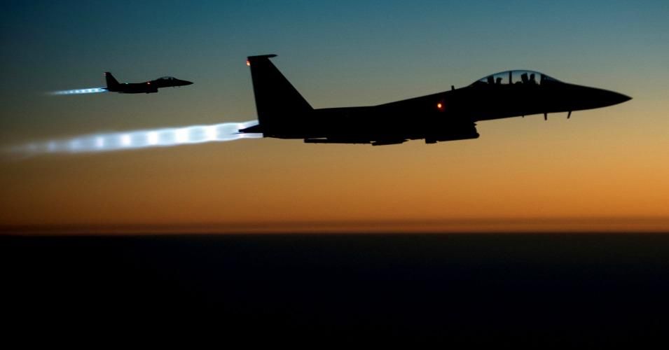 Edited U.S. Air Force image of two F-15E fighters after conducting airstrikes in Syria on Sept. 23, 2014. U.S. Central Command directed the operations. (Photo by Senior Airman Matthew Bruch/USAF via Stuart Rankin/cc/flickr)