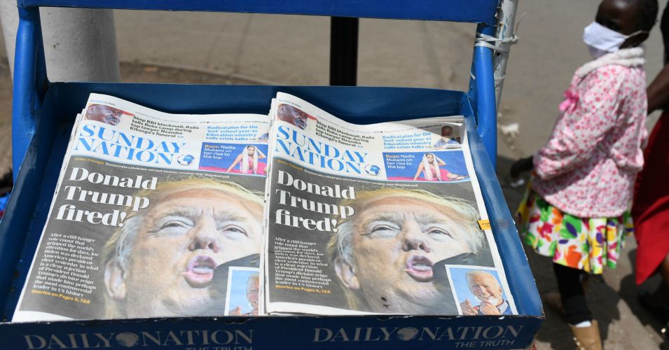 A young girl walks past Kenyan daily newspaper with headline "Donald Trump Fired" in the capital Nairobi on November 8, 2020. (Photo: Simon Maina/AFP via Getty Images)