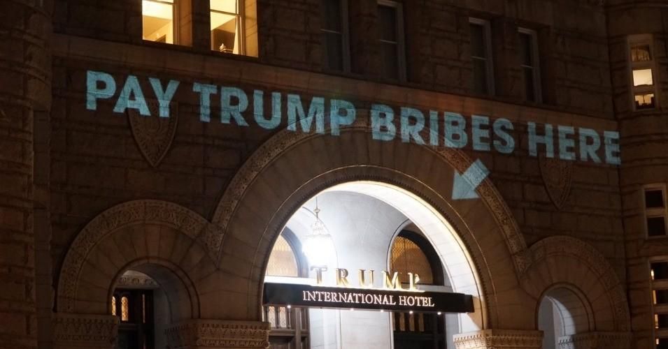 An artist projected "Pay Trump bribes here" and "emoluments welcome" onto the facade of the Trump Hotel in Washington, D.C. in 2017. 