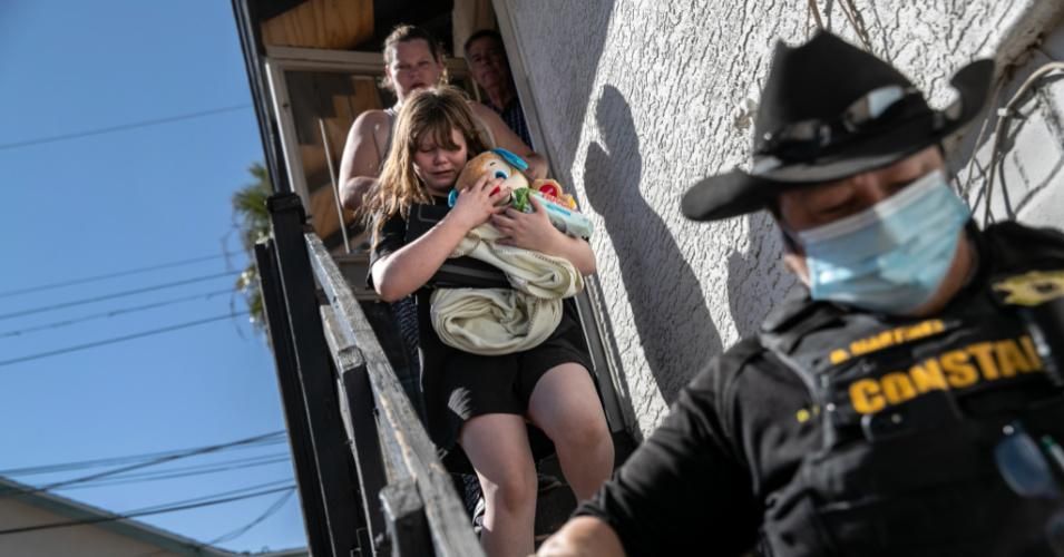 Maricopa County constable Darlene Martinez escorts a family out of their apartment after serving an eviction order for non-payment of rent on September 30, 2020 in Phoenix. (Photo: John Moore/Getty Images)