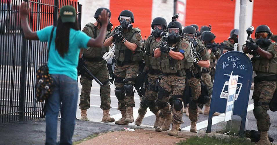 Police force protestors from the business district into nearby neighborhoods on August 11, 2014 in Ferguson, Missouri. Police responded with tear gas and rubber bullets as residents and their supporters protested the shooting by police of an unarmed black teenager named Michael Brown who was killed Saturday in this suburban St. Louis community. (Photo: Scott Olson/Getty Images)