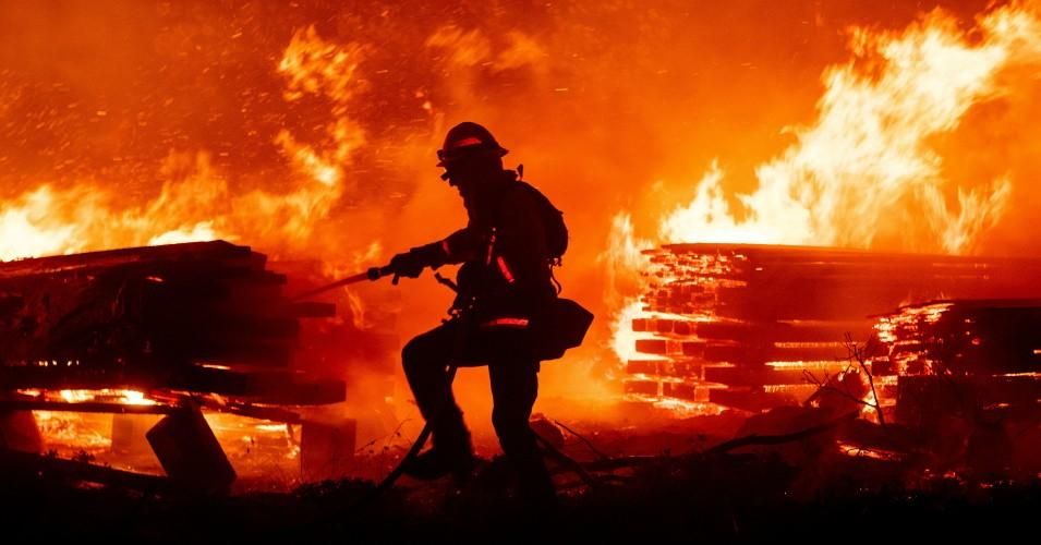 A firefighter douses flames as they push towards homes during the Creek fire in the Cascadel Woods area of unincorporated Madera County, California on September 7, 2020. (Photo: Josh Edelson/AFP via Getty Images)