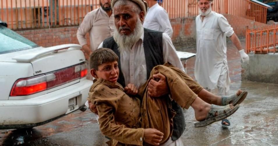 A volunteer carries an injured youth to a hospital following a bomb blast in Haska Mina district of Nangarhar Province on October 18, 2019. 