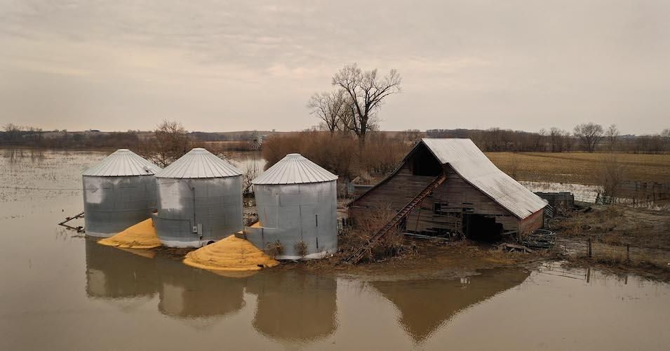 Corn burst from a grain bin which was soaked with floodwater on March 23, 2019, near Union, Nebraska.