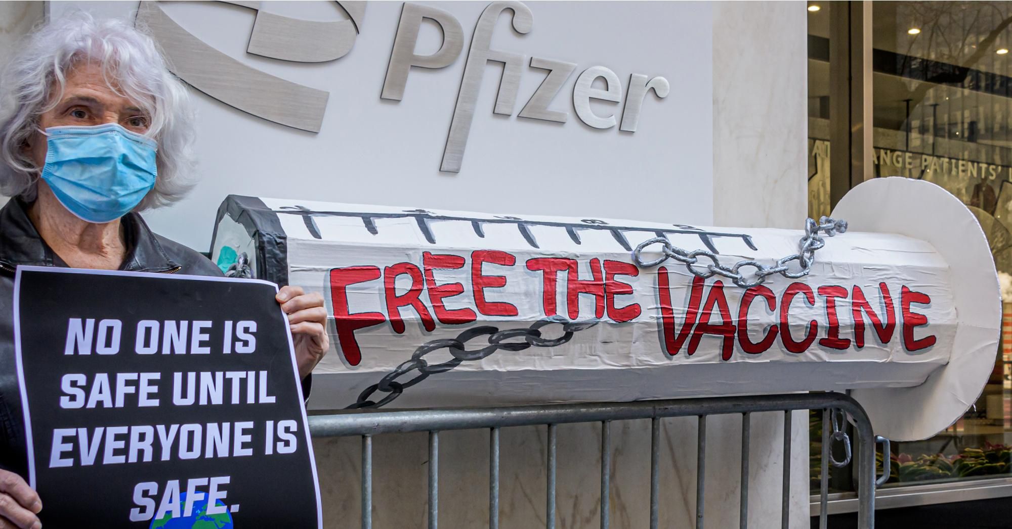 A woman demands Pfizer "free the vaccine" at a March 11, 2021 demonstration outside the company's world headquarters in New York City. (Photo: Erik McGregor/LightRocket via Getty Images)