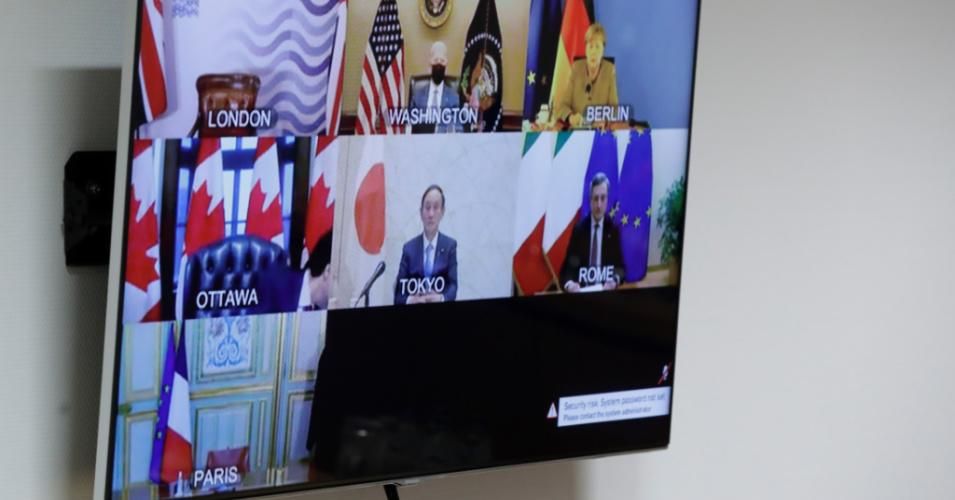 G7 head of states are seen on-screen during a virtual summit on February 19, 2021. (Photo: Olivier Hoslet/AFP via Getty Images)