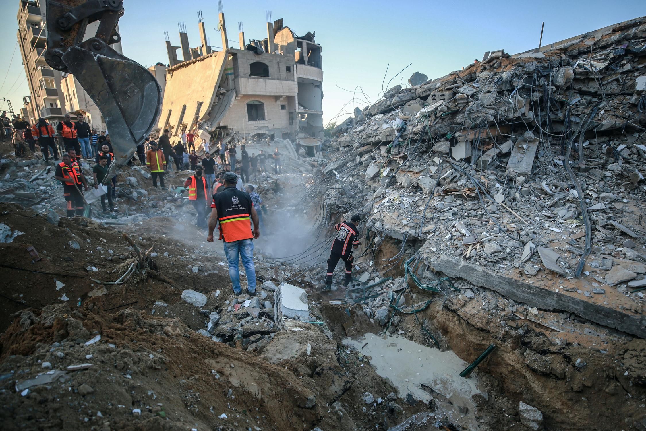 Palestinian first responders search through the rubble of a family's home in Beit Lahia, Gaza following Israeli bombing on May 13, 2021. The body of a child—one of at least 27 killed by Israeli bombing—was recovered from the home's ruins. (Photo: Mustafa Hassona/Andalou Agency via Getty Images)