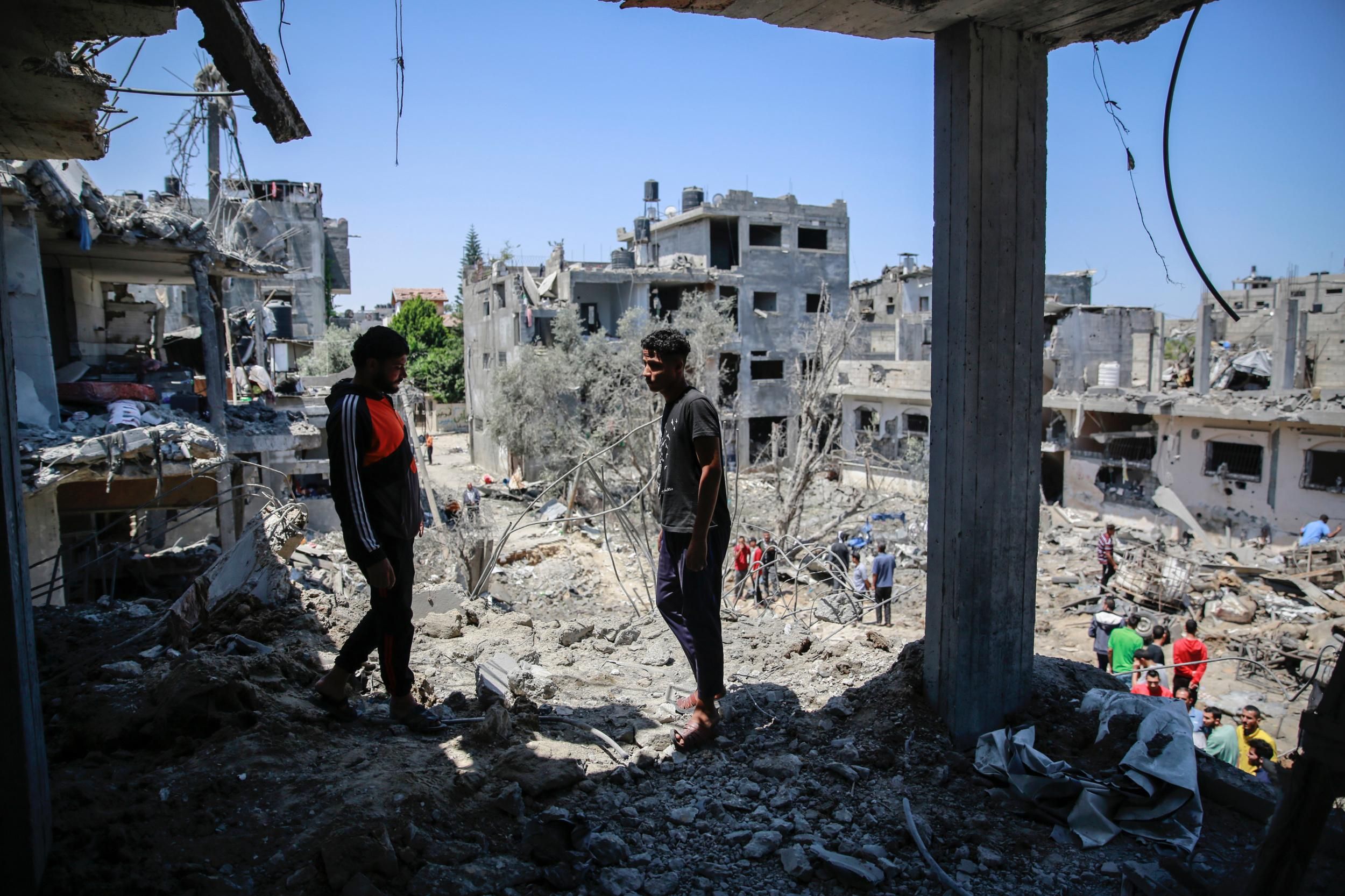 Gaza residents gather at the site of homes destroyed by Israeli air and artillery attacks on May 14, 2015. (Photo: Ahmed Zakot/SOPA Images/LightRocket via Getty Images) 