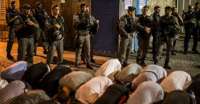 Palestinians pray outside the Old City