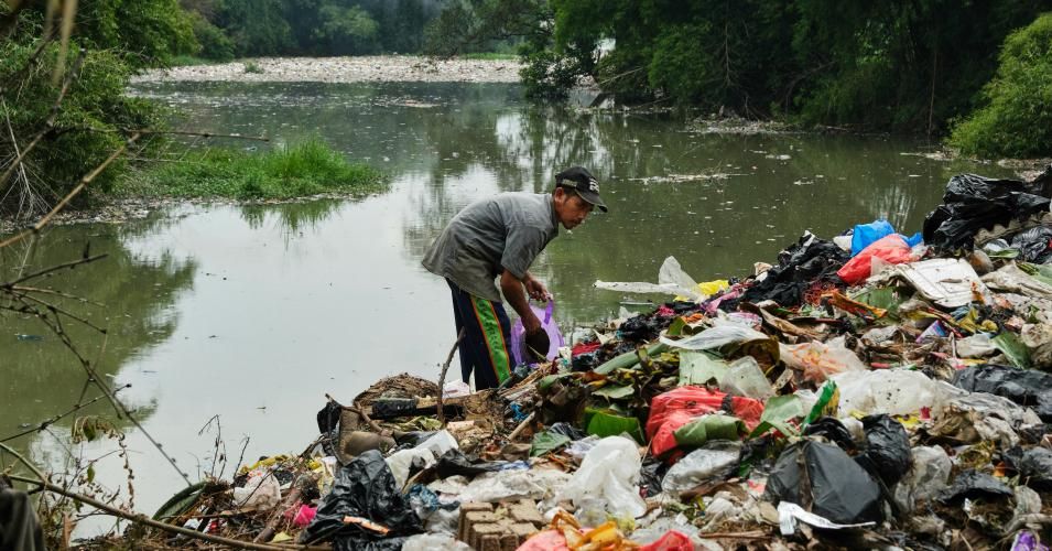 A man collects plastic waste 