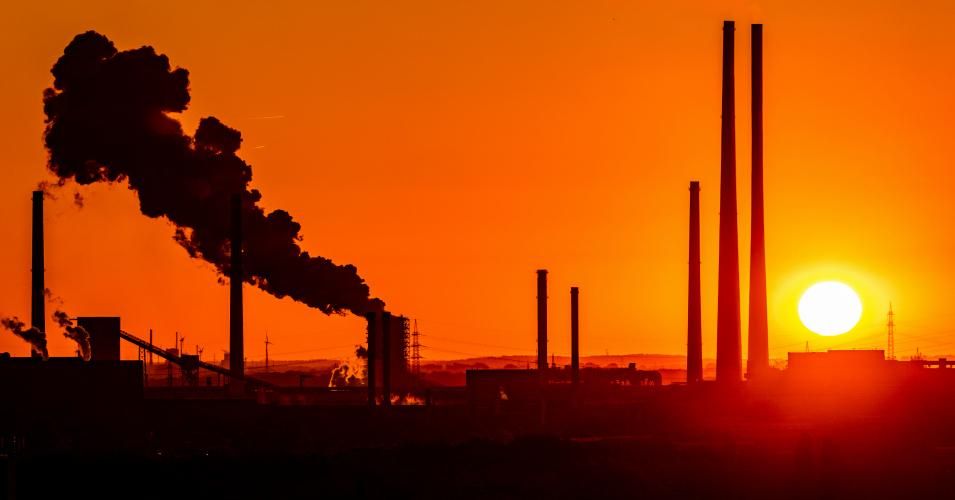 The sun goes down behind chimneys at a coal plant in Duisburg, Germany on June 28, 2019. (Photo: Marcel Kusch/dpa/picture alliance via Getty Images)