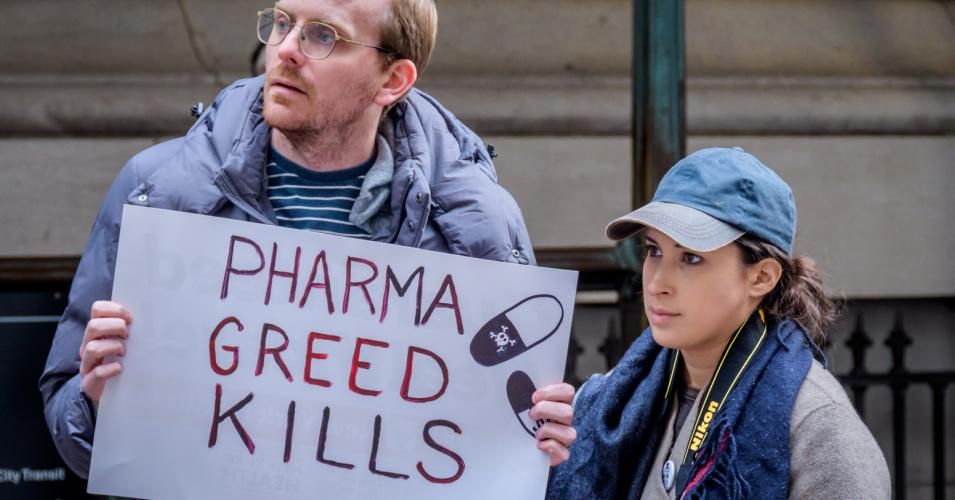 (Taken Pre-Pandemic) A demonstrator holds a sign at a rally in front of the New York Stock Exchange on November 14, 2019.