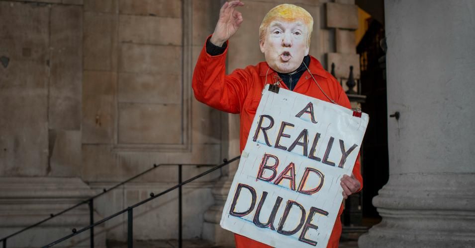 A man wearing an orange prison outfit and a Donald Trump mask during a protest against the U.S. president's U.K. visit to attend the NATO summit on December 3, 2019 in London.