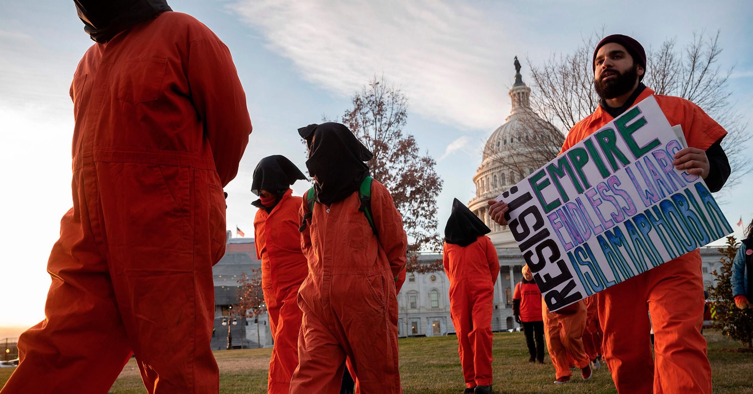 Demonstrators dressed in Guantánamo Bay prisoner uniforms march past Capitol Hill in Washington, D.C., on January 9, 2020. (Photo: Jim Watson/AFP via Getty Images)