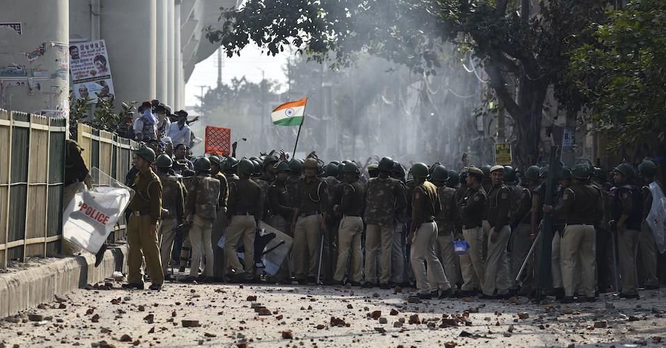 Police personnel and protestors seen during anti-Muslim attacks at Jaffrabad on February 24, 2020 in New Delhi, India. 