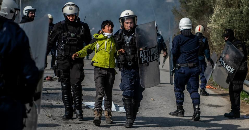 Greek riot police detained a migrant during clashes 