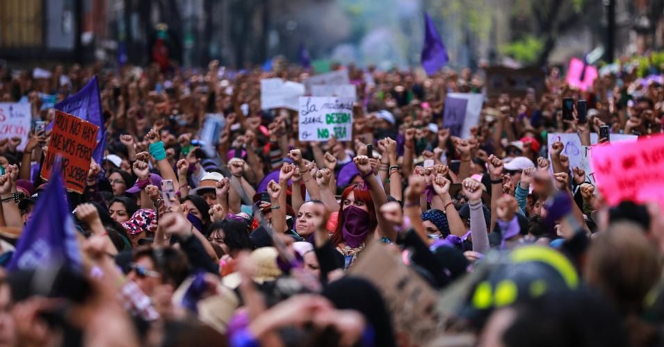 Women raise their fists a protest on the International Women's Day in Mexico City on March 8, 2020