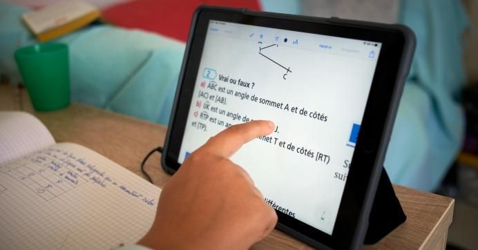 A pupil does math on a tablet in Toulouse, France on March 24, 2020.
