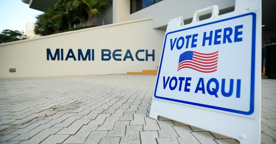A sign directed voters to a polling location during the Florida presidential primary on March 17, 2020 at Miami Beach City Hall in Miami Beach, Florida. People headed to the polls to vote for their Republican and Democratic choice in their parties’ respective primaries during the Covid-19 outbreak. 