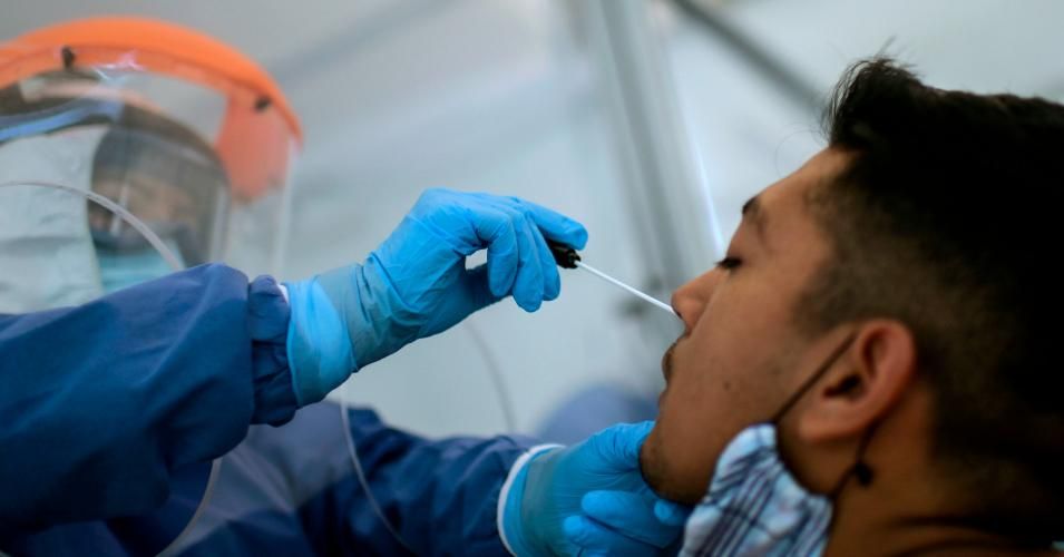 A health worker takes samples from a man to test him for Covid-19 at the Biological Sciences unit of the National Polytechnic Institute (IPN) in Mexico City on May 25, 2020. 