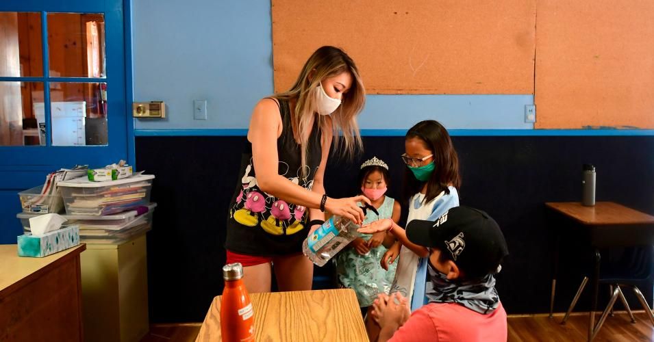 Hand sanitizer is offered to students as per coronavirus guidelines during summer school sessions at Happy Day School in Monterey Park, California on July 9, 2020. (Photo: Frederic J. Brown/AFP via Getty Images)