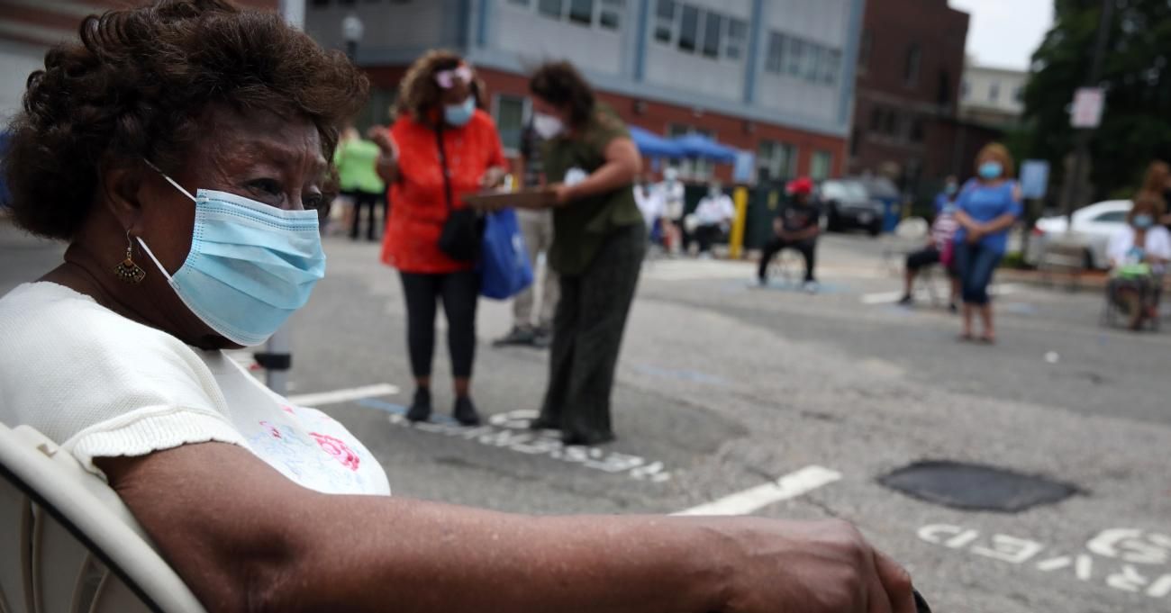 A woman waits to be tested for Covid-19 outside the Catherine Hardaway Residences in the Roxbury neighborhood of Boston on July 8, 2020.