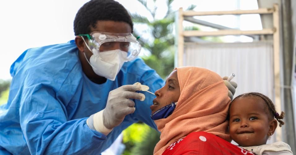 A medical worker collects a swab sample from a mother for Covid-19 tests at a hospital in Addis Ababa, Ethiopia on August 16, 2020.