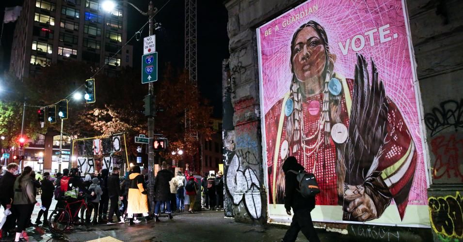 Protestors walk past an image of a Native American woman during a march to "Count Every Vote, Protect Every Person" after the U.S. presidential Election in Seattle, Washington on November 4, 2020. (Photo: Jason Redmond/AFP via Getty Images)