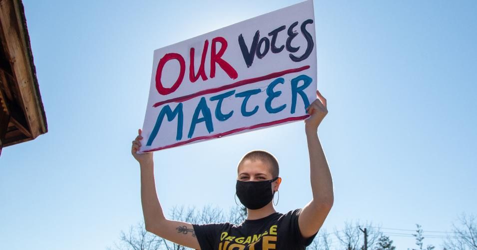 A protester holds a sign reading "our votes matter" at a Count Every Vote protest near Bucknell University in Lewisburg, Pennsylvania on November 4, 2020.