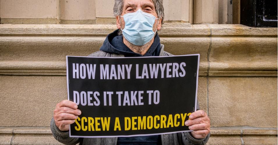 A demonstrator seen holding a sign during protest in Manhattan on November 19, 2020.