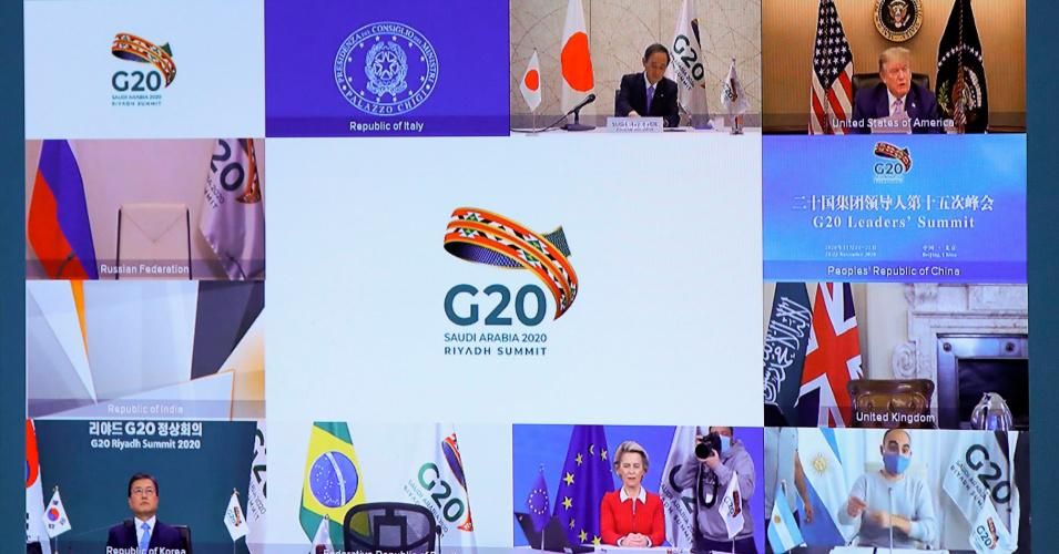 Japanese Prime Minister Yoshihide Suga (top L), U.S. President Donald Trump (top R), South Korean President Moon Jae-in (down L), and European Commission President Ursula von der Leyen (down C) are seen on a screen before the start of a virtual G20 summit hosted by Saudi Arabia and held over video conference amid the Covid-19 pandemic, in Brussels, on November 21, 2020. (Photo: Yves Herman/POOL/AFP via Getty Images)