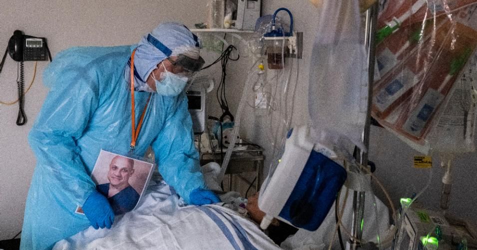 Dr. Joseph Varon talks to a patient in the Covid-19 intensive care unit (ICU) during Thanksgiving at the United Memorial Medical Center on November 26, 2020 in Houston, Texas.