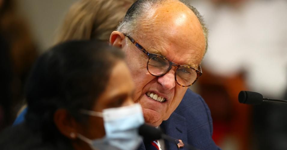U.S. President Donald Trump's personal attorney Rudy Giuliani listens to Detroit poll worker Jessi Jacobs during an appearance before the Michigan House Oversight Committee on December 2, 2020 in Lansing, Michigan. (Photo: Rey Del Rio/Getty Images)