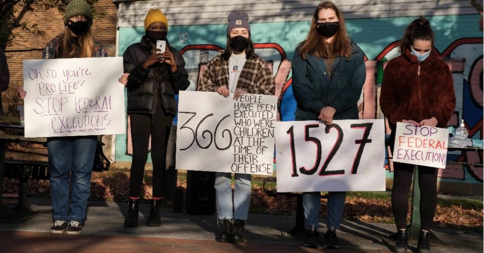 College students and community members wearing face masks hold placards while gathering in Bloomington, Indiana to protest against the death penalty and a wave of executions at the Terre Haute federal prison during the final months of President Donald Trump's administration. (Photo: Jeremy Hogan/SOPA Images/LightRocket via Getty Images)