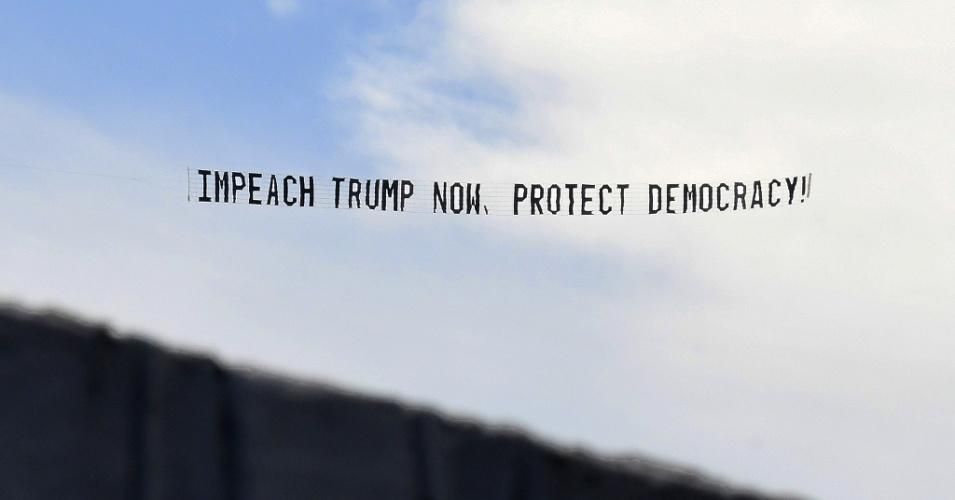 A banner towed by a plane calls for the impeachment of President Donald Trump on January 7, 2021.