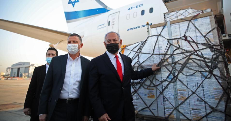 Israel's Prime Minister Benjamin Netanyahu and Health Minister Yuli Edelstein attend a ceremony for the arrival of a plane carrying a shipment of the Pfizer-BioNTech coronavirus vaccine at Ben Gurion airport near Tel Aviv on January 10, 2021.