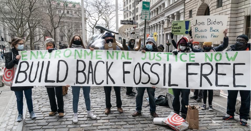 At a January 19, 2021 rally organized by Food & Water Watch, New York Communities for Change, and 350 NYC, environmental activists demand that the Biden administration Build Back Fossil Free in front of Charging Bull sculpture in New York City. (Photo: Lev Radin/Pacific Press/LightRocket via Getty Images)