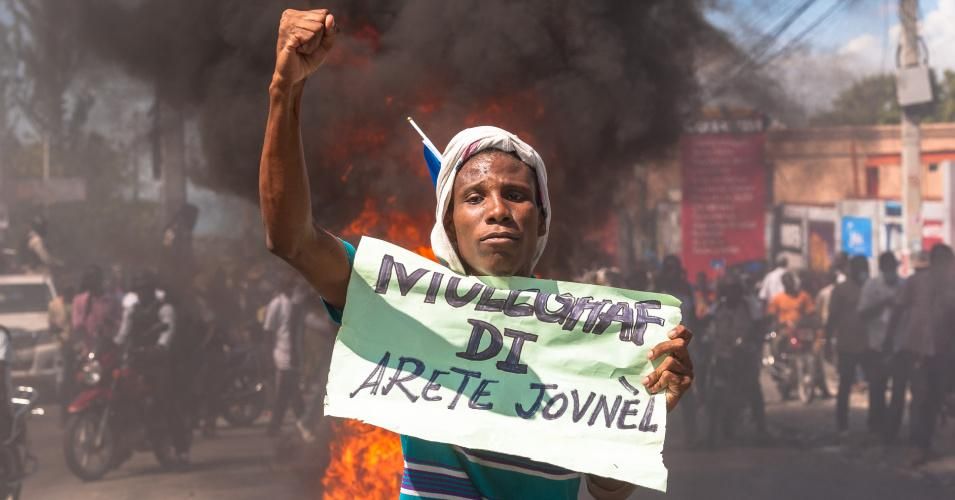 Demonstrators march in Port-au-Prince on February 14, 2021 to protest against the government of Jovenel Moise.