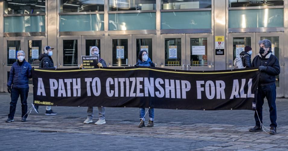 Protesters holding a banner that reads, "A Path to Citizenship for All" at a silent demonstration in Manhattan on February 25, 2021.