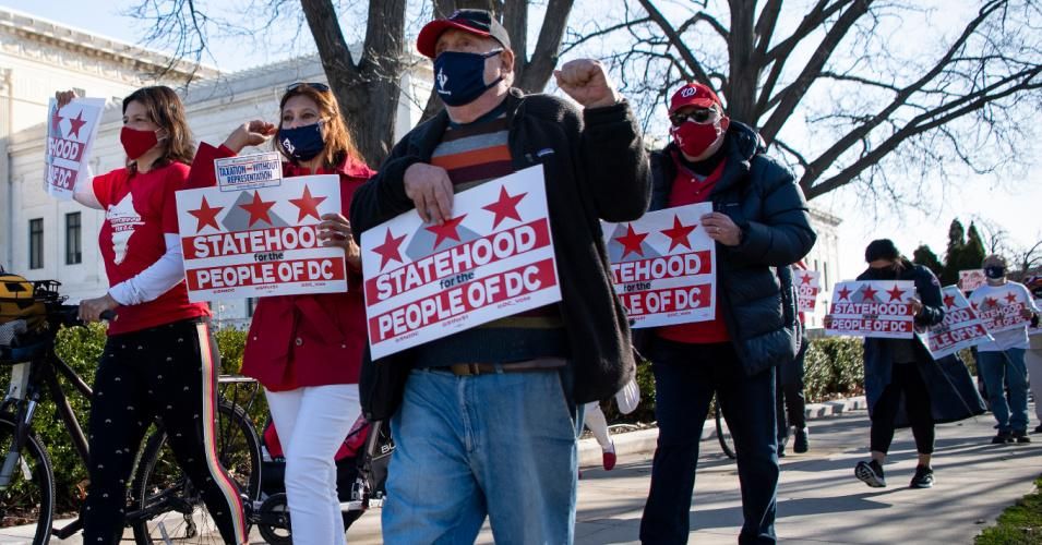 D.C. statehood activists walk by the U.S. Supreme Court to show support ahead of the House Oversight and Reform Committee hearing on March 22, 2021.