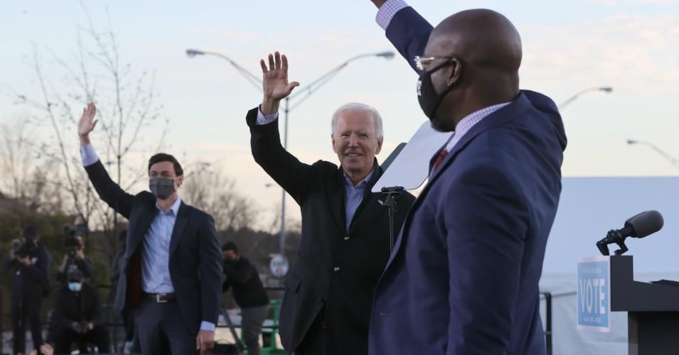 President-elect Joe Biden (C), along with Democratic candidates for the U.S. Senate Jon Ossoff (L) and Rev. Raphael Warnock (R), greet supporters during a campaign rally the day before their runoff elections in the parking lot of Centerparc Stadium in Atlanta on January 4, 2021. (Photo: Chip Somodevilla/Getty Images)
