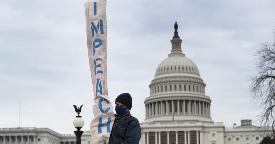 Bill Zawacki carries a banner that reads "impeach" near the U.S. Capitol two days after a pro-Trump mob broke into the building on January 8, 2021 in Washington, D.C. (Photo: Joe Raedle/Getty Images)