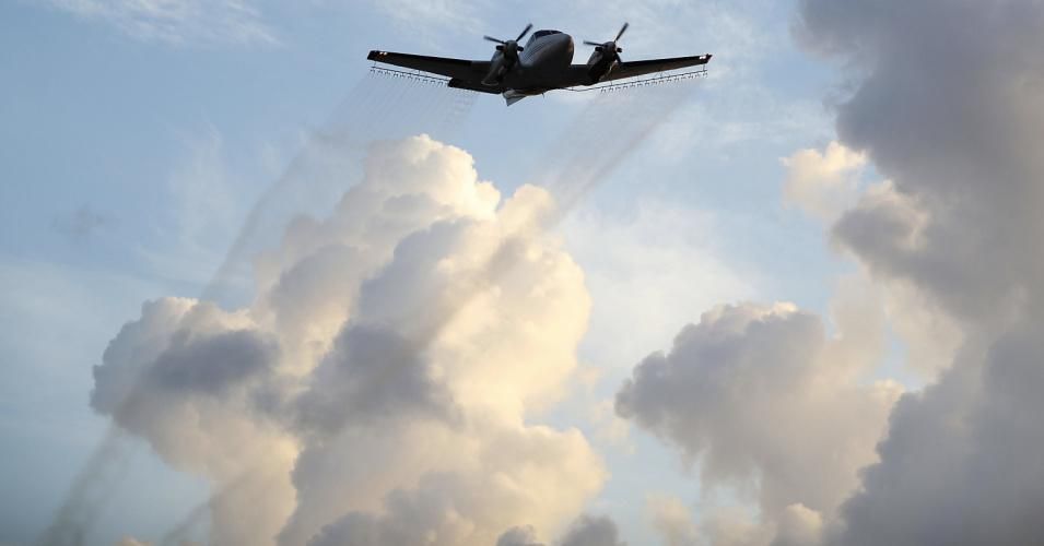 A plane sprays pesticide over the Wynwood neighborhood in the hope of controlling and reducing the number of mosquitos, some of which may be capable of spreading the Zika virus on August 6, 2016 in Miami, Florida. (Photo: Joe Raedle/Getty Images)