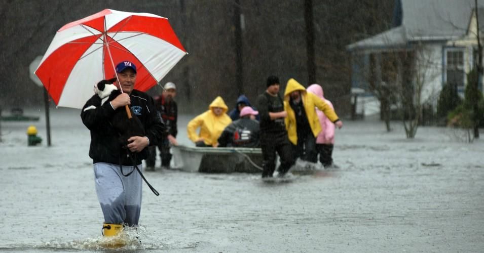Roy Casey carries his dog Buddy from his flooded neighborhood on March 30, 2010 as the Pawtuxet River crests in Cranston, Rhode Island. A major rain storm hammered the Northeast, causing flooding and evacuations. National Guard troops were activated in Massachusetts and Rhode Island. (Photo: Darren McCollester/Getty Images)
