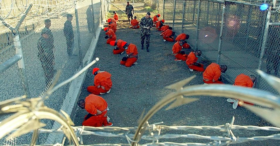 Prisoners seen here hooded and shackled at the U.S. Navy prison in the Guantánamo Bay Naval Base in Cuba. (Photo: U.S. Navy/Flickr Creative Commons)