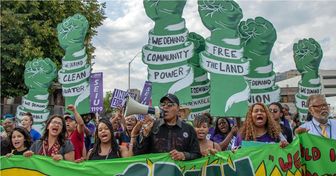 Rep. Rashida Tlaib (D-Mich.; front row, second from left) takes part in the July 31, 2019 "Make Detroit the Engine of the Green New Deal" rally. (Photo: Becker1999/Flickr/cc)