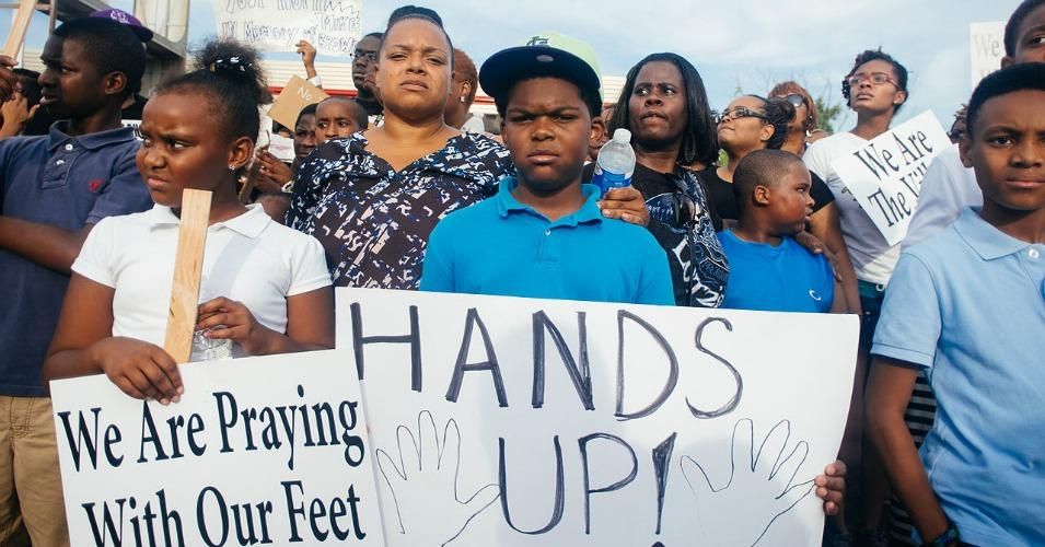 "Hands up!" sign displayed at a Ferguson protest. (Photo: Jamelle Bouie/flickr/cc)