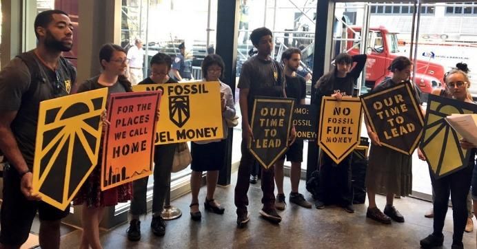 Climate activists rally at Gov. Andrew Cuomo's office to demand he reject fossil fuel cash. 