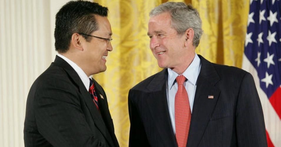 In 2007, Kay Hiramine, pictured here with President George W. Bush, was awarded the president's Volunteer Service Award—despite serving as a paid operative of the U.S. Department of Defense. (Photo: White House archives)